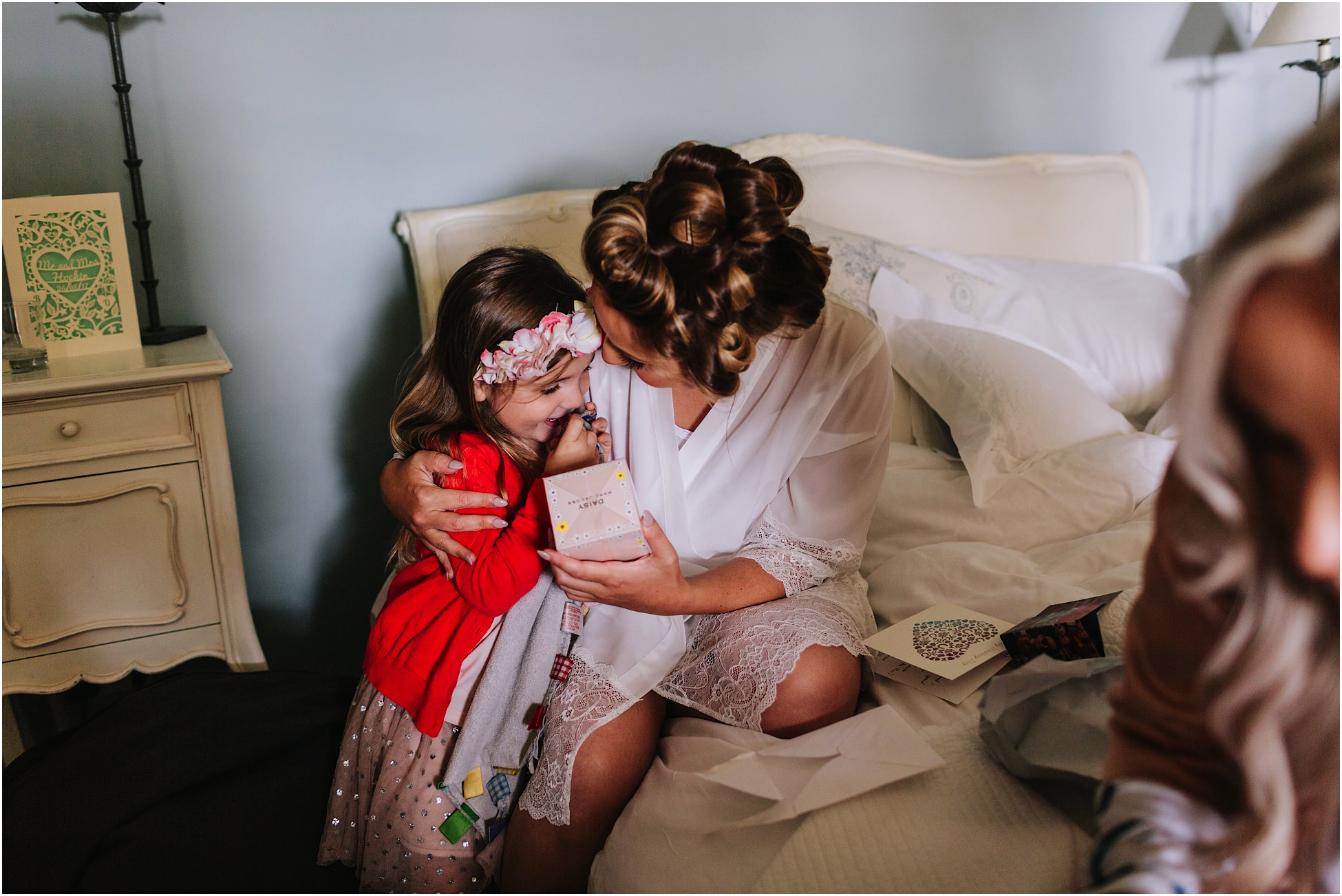 Bride and flower girl hug