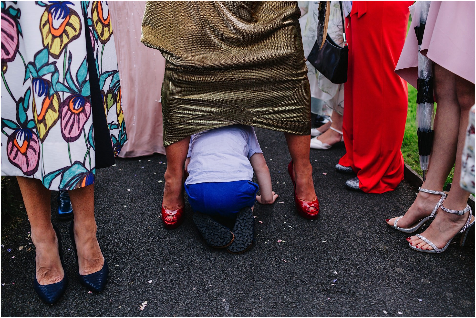 Belmount Hall wedding - a little boy crawls through legs