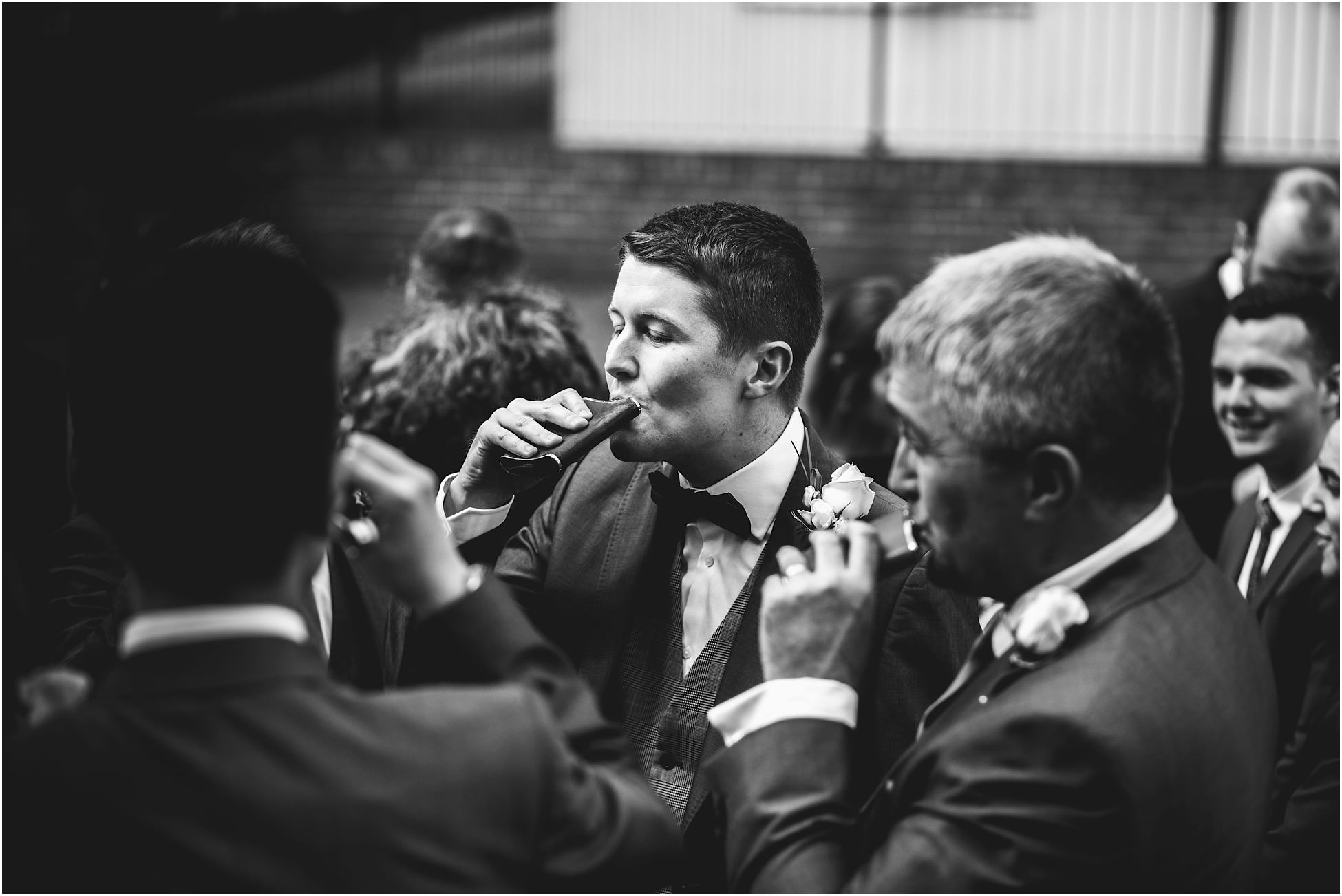 Groom drinking from a hip flask
